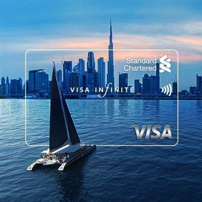 transparent visa infinite credit card shown with a background of tall building and yacht