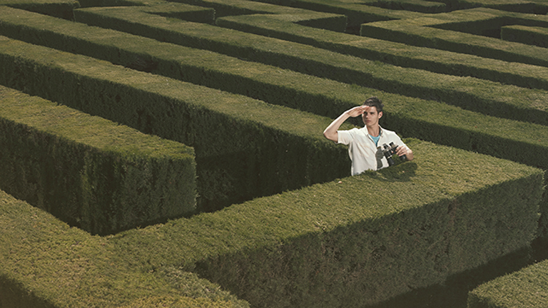 man looking for direction in a maze