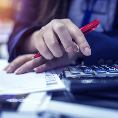 woman calculating savings account interest rate using calculator