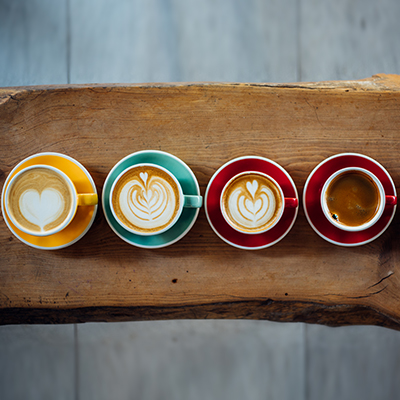 four cups of coffee placed on their saucers depicting various wealth lending options