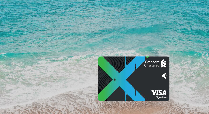 x credit card shown in the background of beach