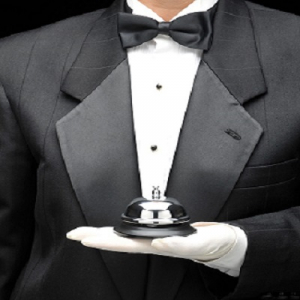 Px photo id butlers holding call bell in gloved hand in front of body torso only