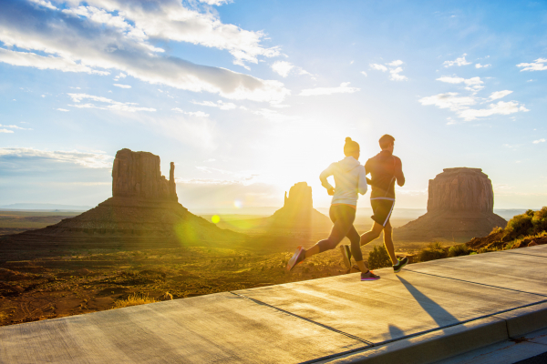 Px photo id caucasian couple running in monument valley utah united states