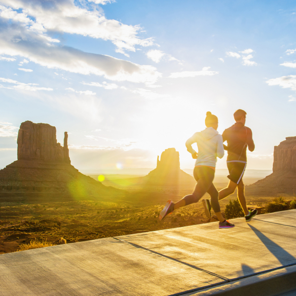 Px photo id caucasian couple running in monument valley utah united states