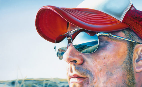 Man in red and white hat looking into the distance