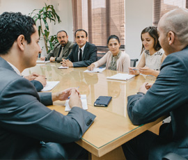 People around a board table discussing events