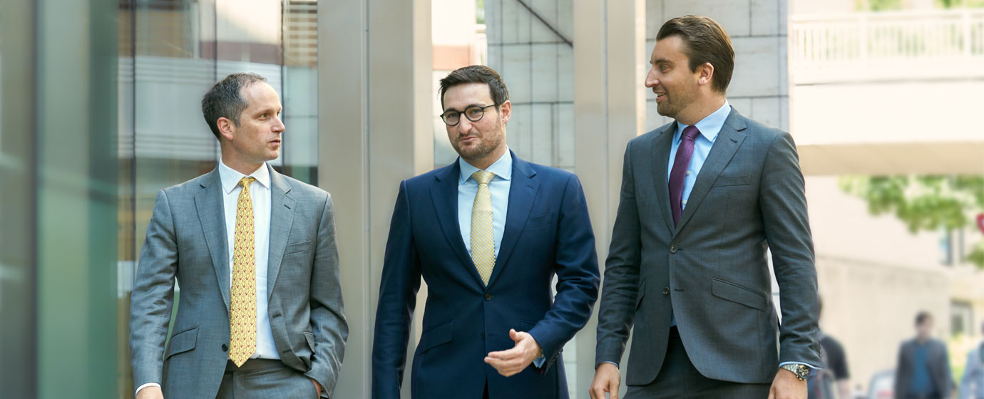 Three business men walking down the street