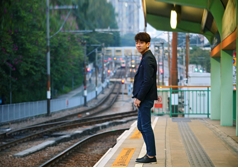 person standing alone on train platform