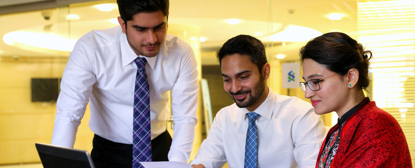 Three colleagues discussing cash management