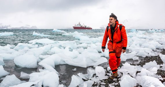 Scientist inspecting melting icebergs