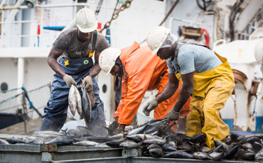 Three men in Ghana on fishing boat