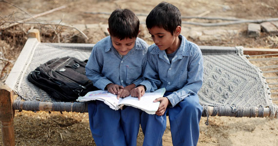 Two Indian schoolboys with book