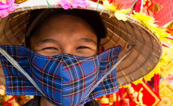 woman in straw hat with cloth face mask