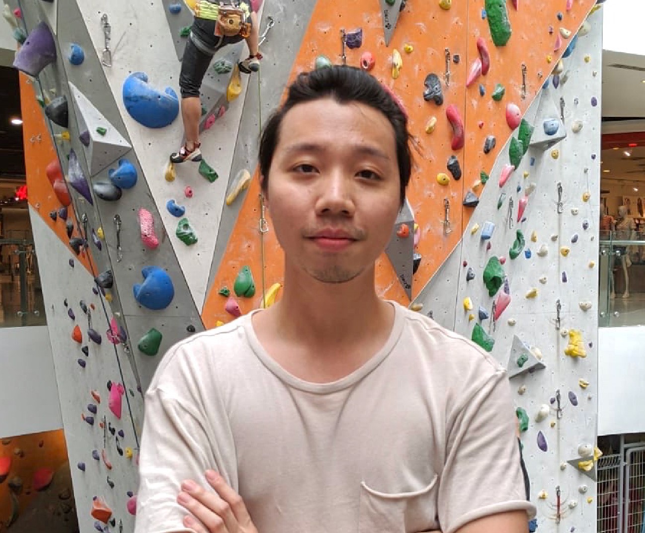 man standing in front of climbing wall