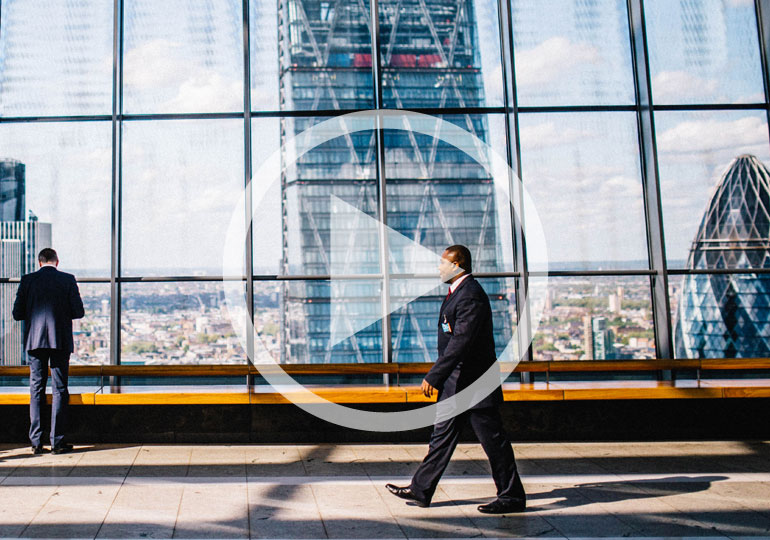 man walking past large window