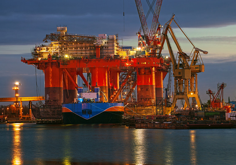 oil rig lit up at night