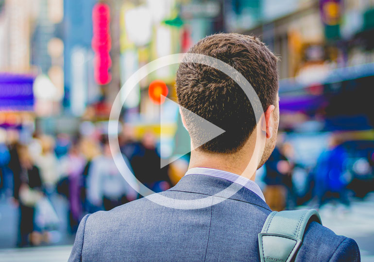 man walking along busy street