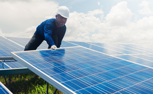 Man adjusting solar panels