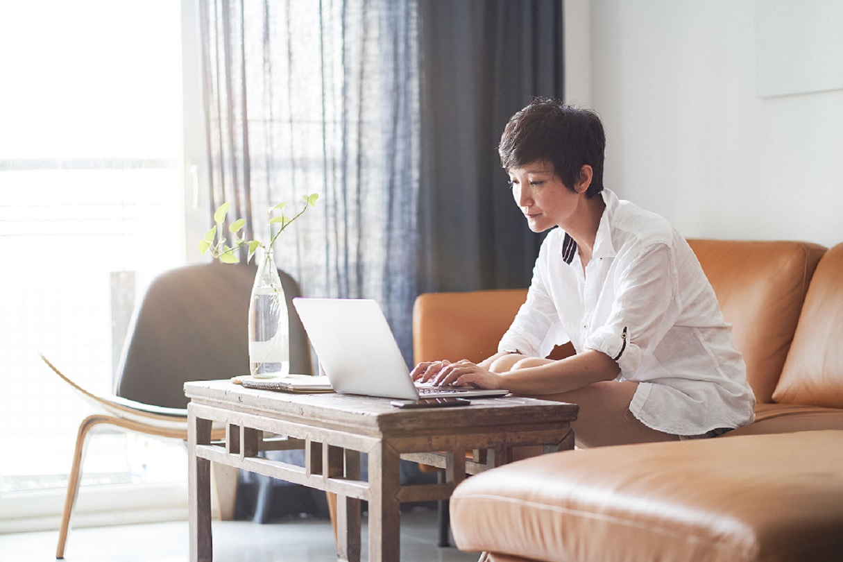 woman working from home using laptop on coffee table