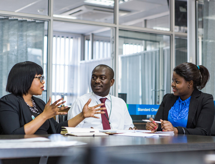 Three staff members talking about responsible selling
