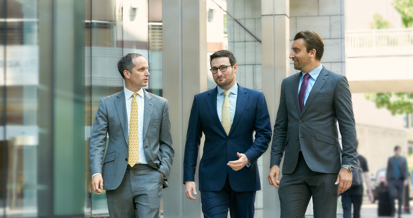 Three shareholders walking down the street
