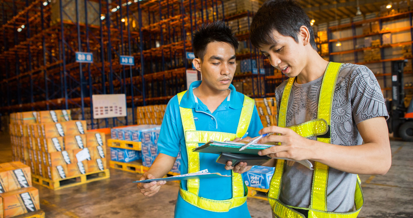 Men in goods warehouse