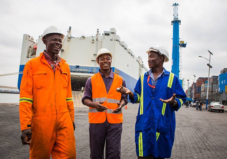 3 workers standing in front of ship