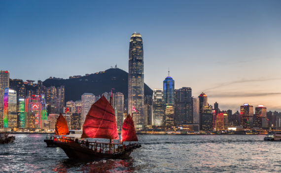 Traditional junk boat sailing across Victoria Harbour, Hong Kong.