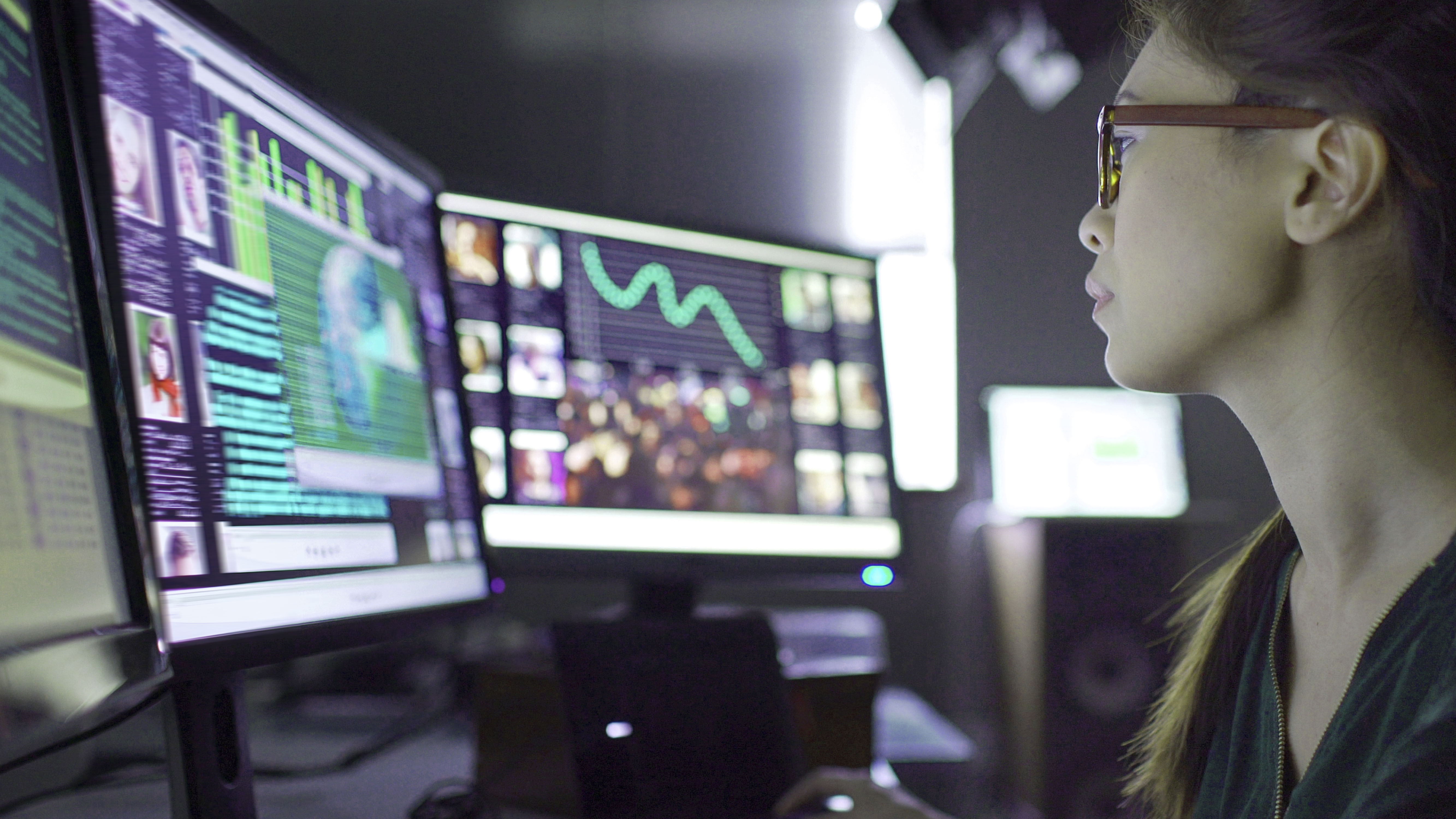 Image of a young asian woman sitting down at her desk