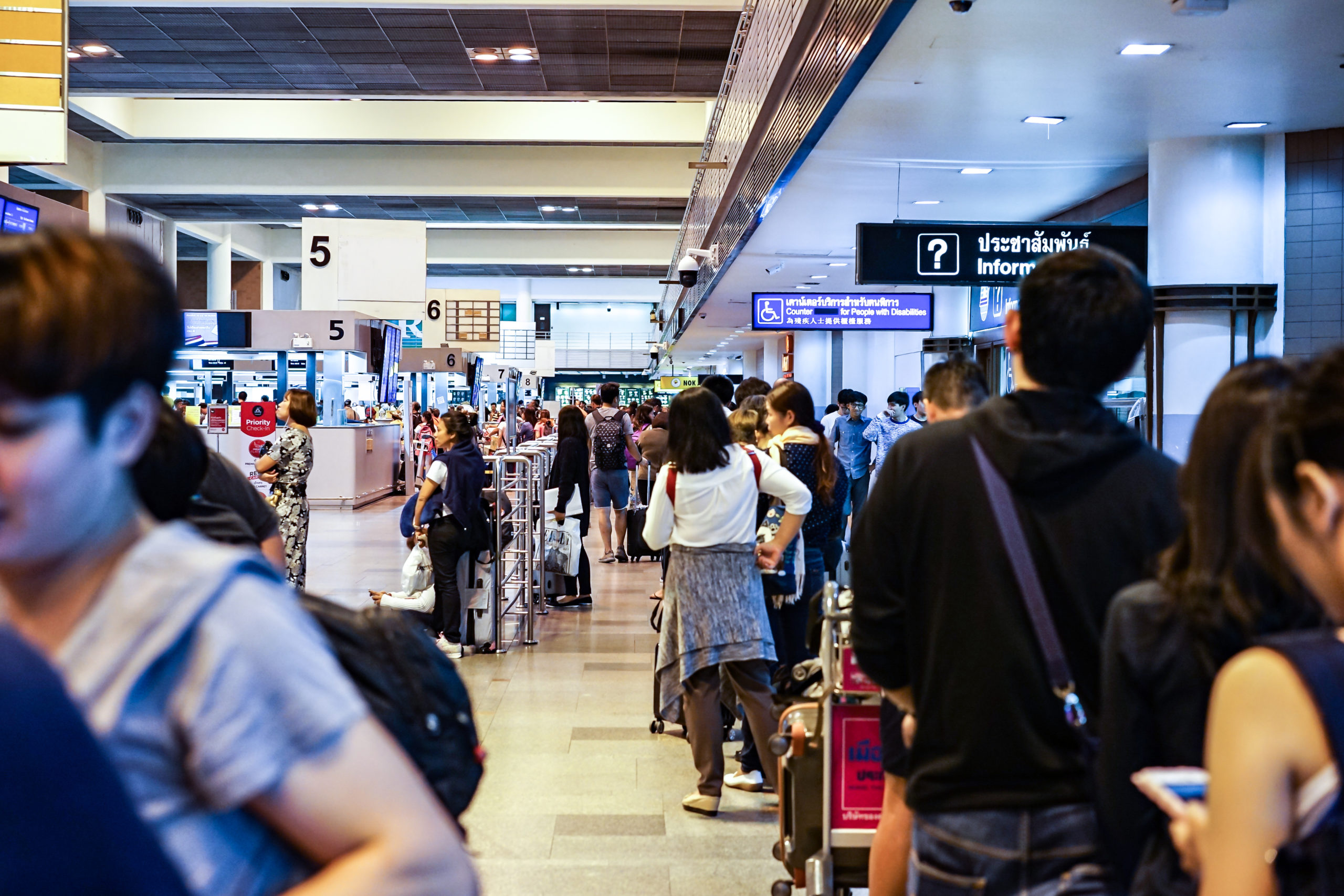 Travellers and passengers in the line are waiting for check in at Donmuang International Airport, Bangkok, Thailand