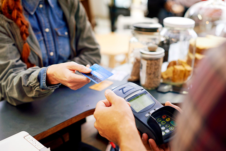 Image of someone paying by card