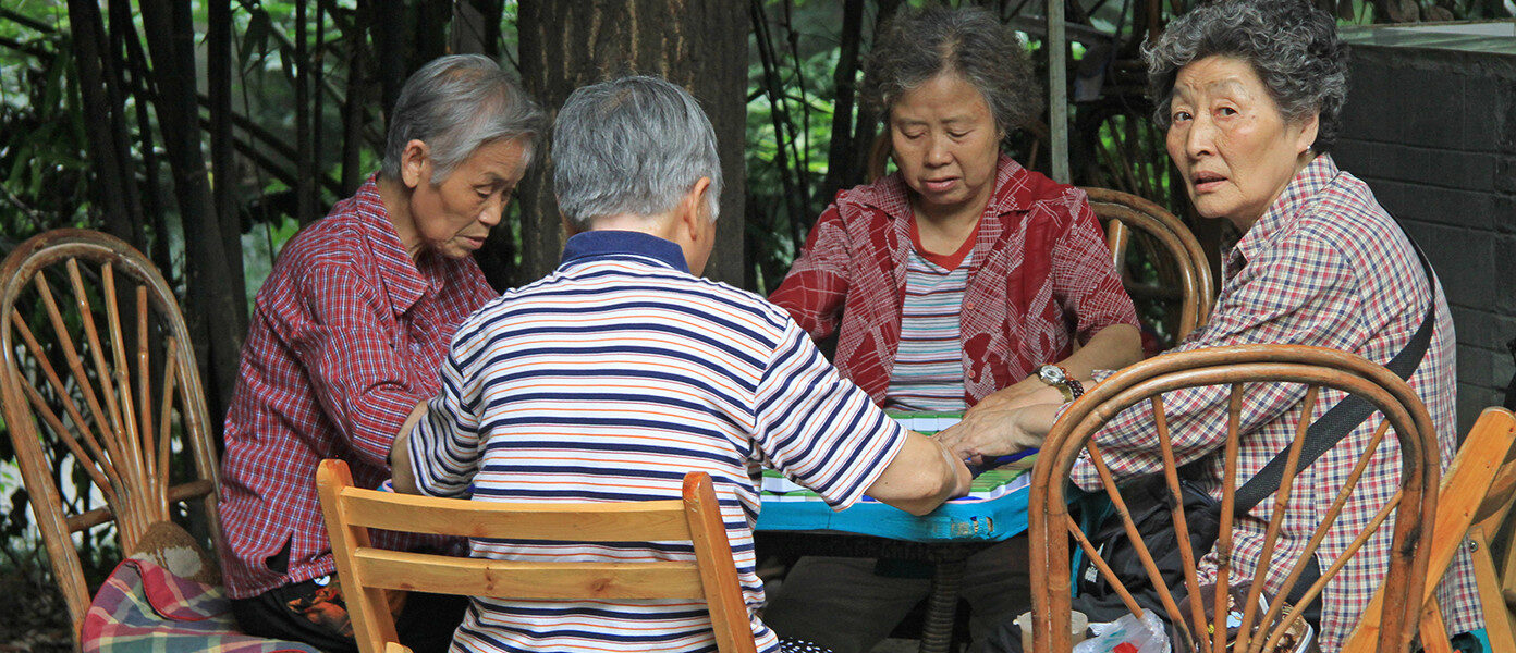 elderly people playing mahjong outdoors