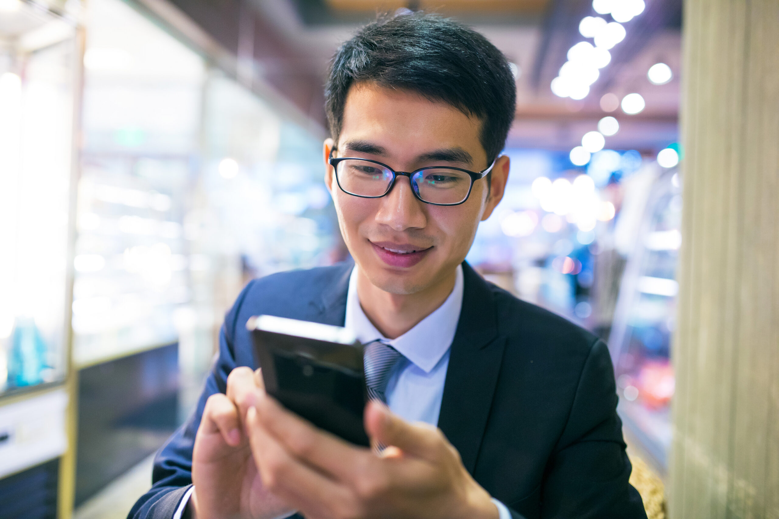 man using phone indoors