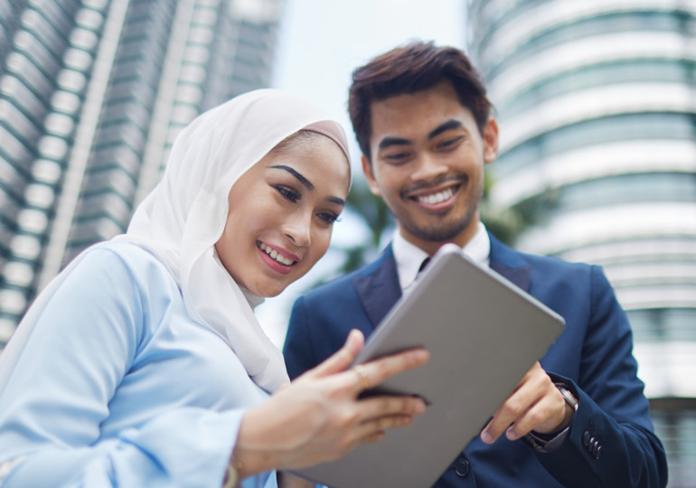 Man and woman looking at tablet