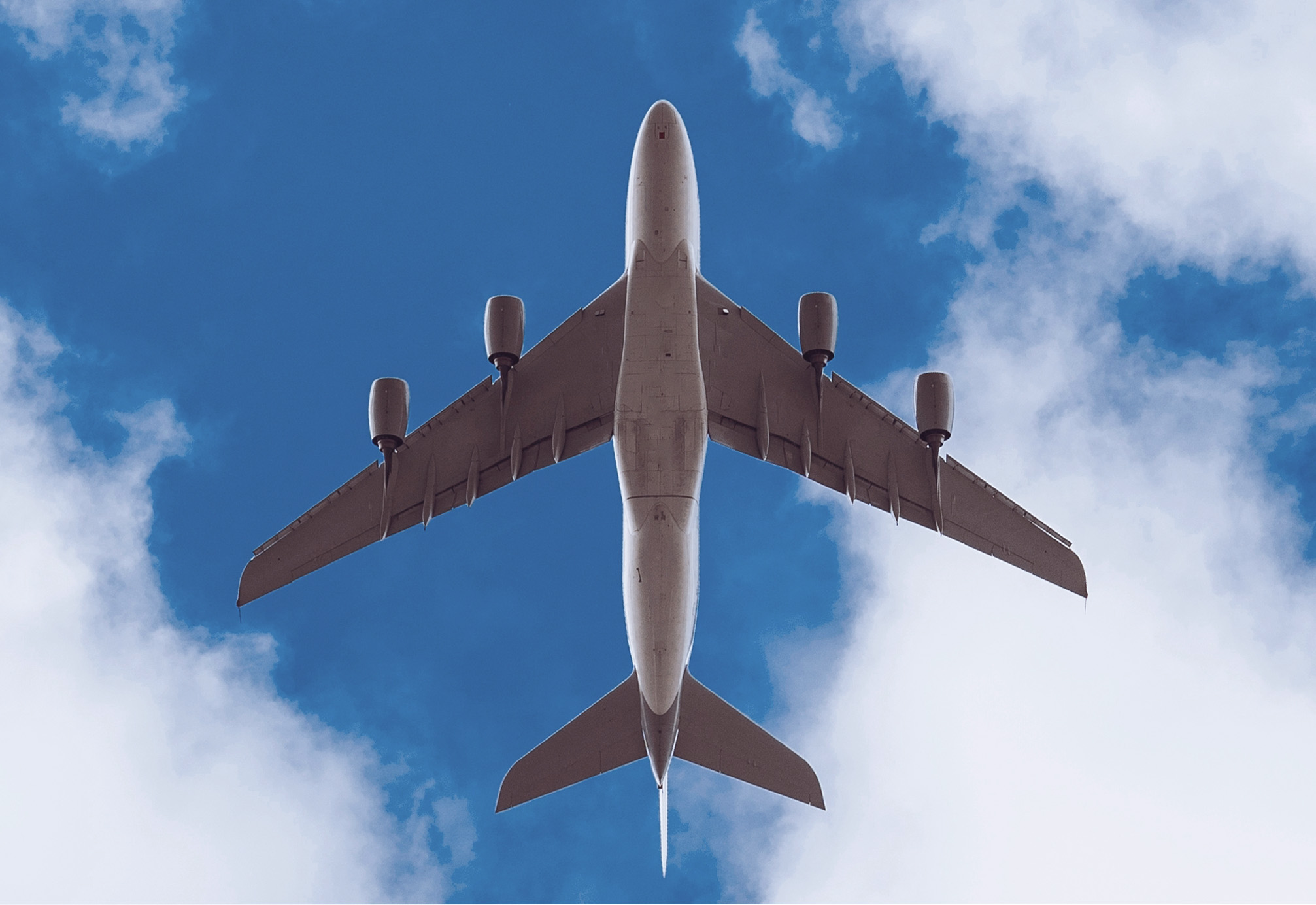 A cargo plane carrying DHL documents flies overhead.