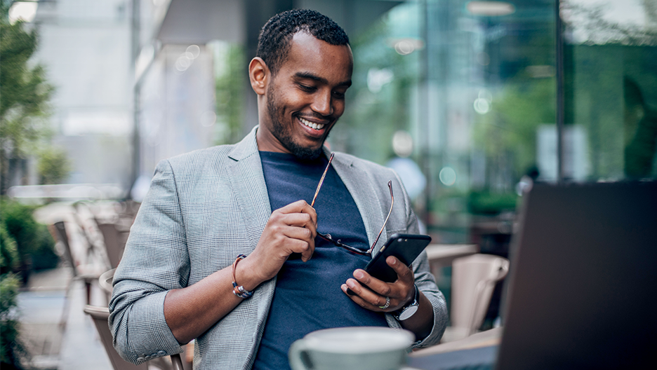 A man looks at signature CIO funds on his phone.