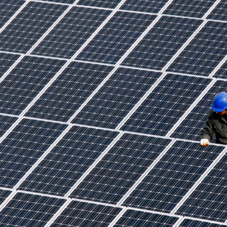 A man repairs solar panels