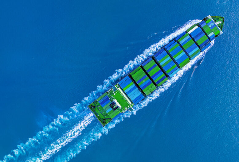 A ship transporting blue and green containers.