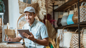 A small business owner works on an iPad. SC Ventures backs several fintechs which provide services to SMEs.