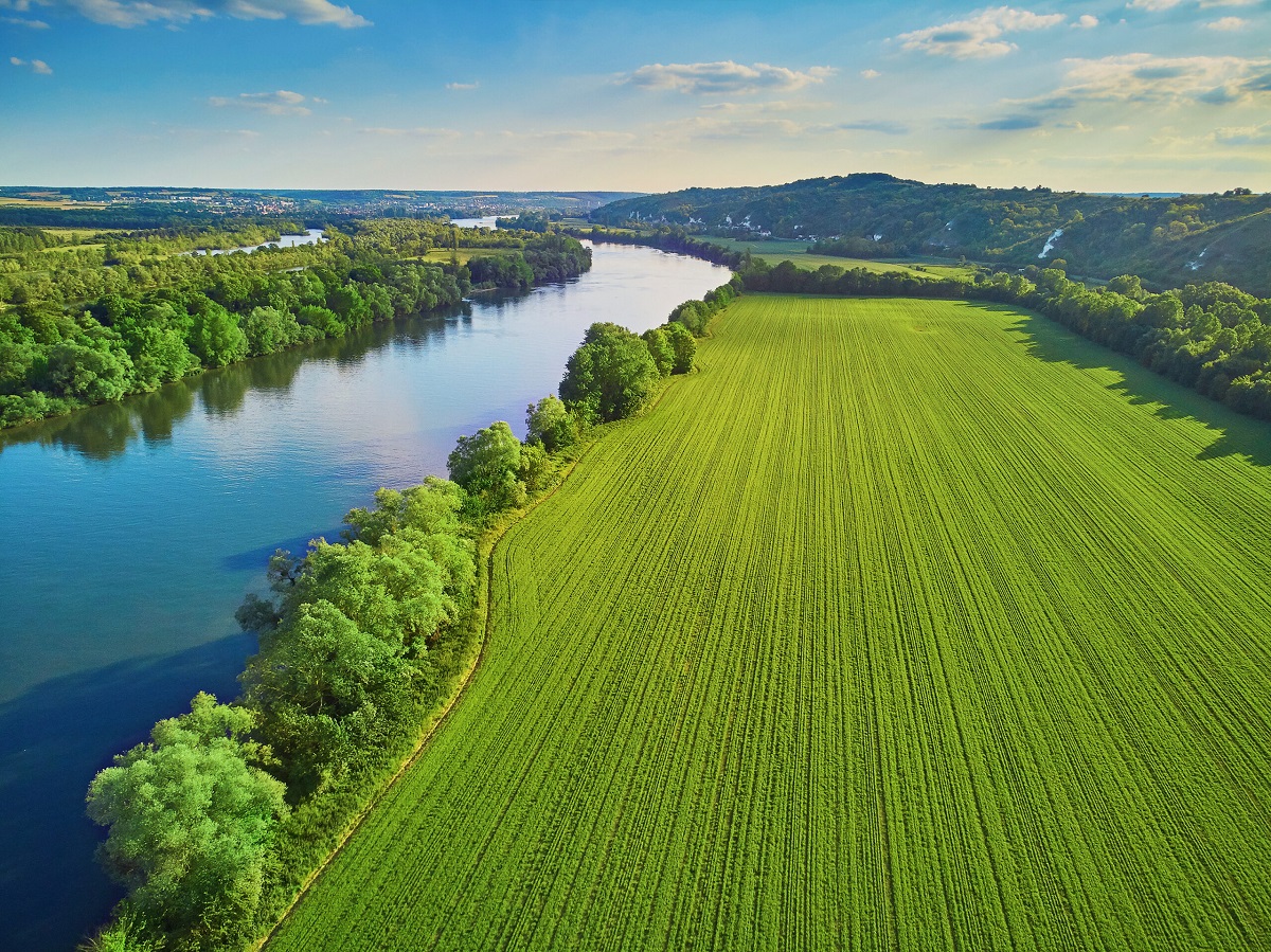 Green field with lake on the left side