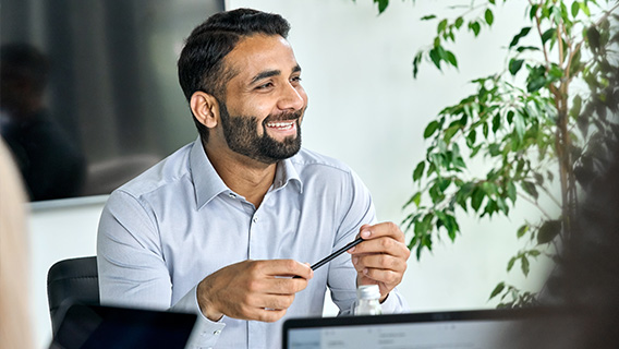 An investor smiles in a meeting.