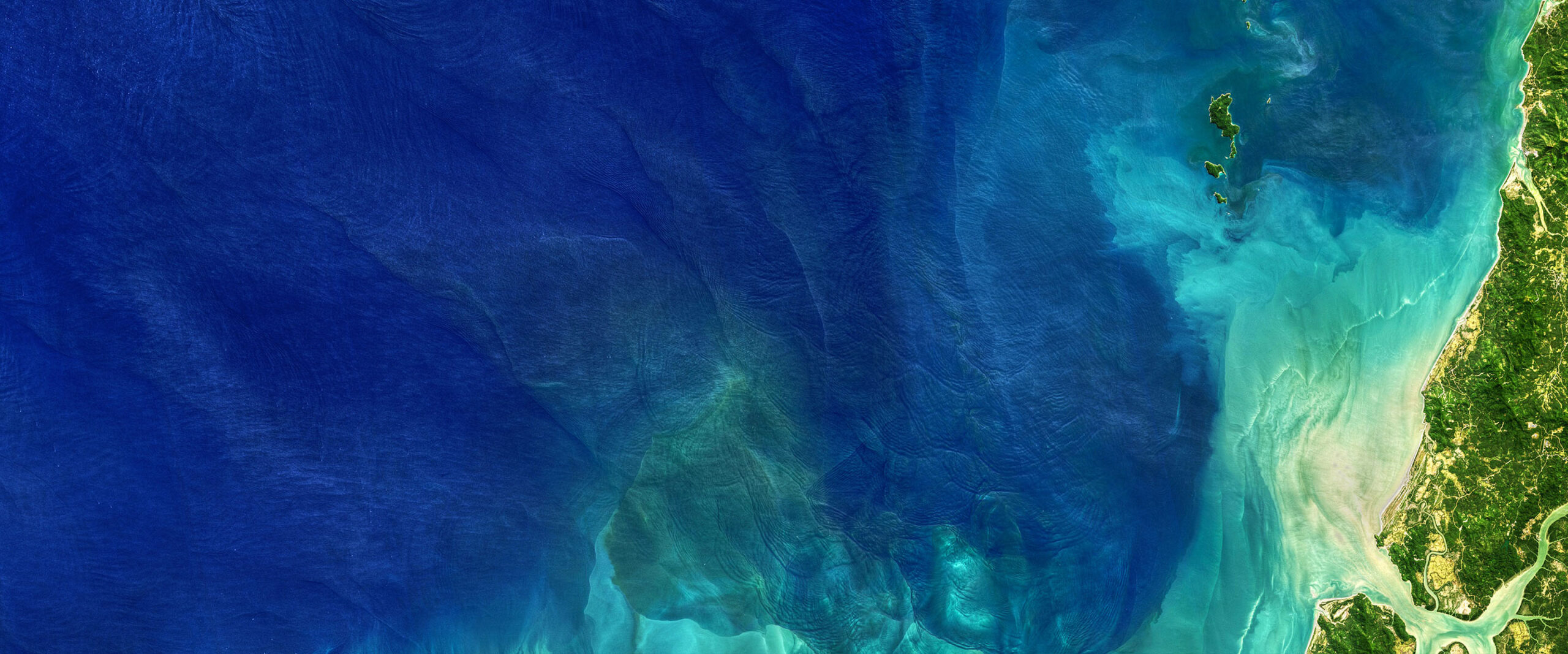 An ocean shoreline seen from above.