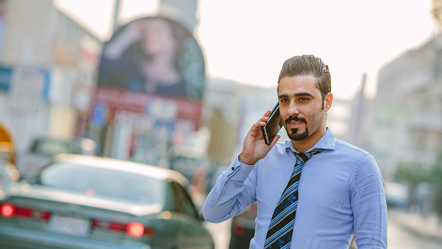 man talking on phone outside