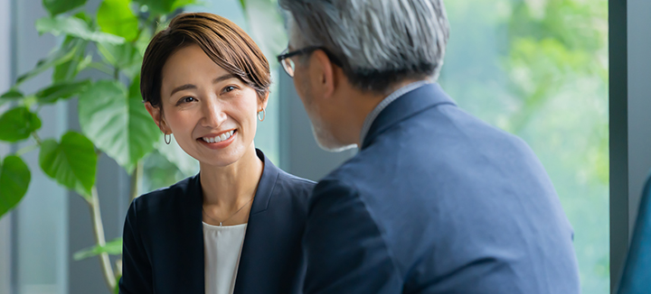 A woman greets a corporate client.