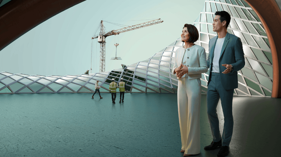 A man and woman stand together in front of a modern building