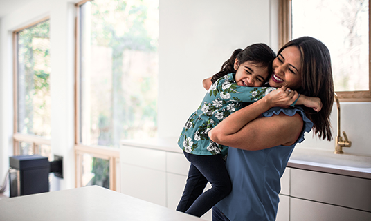 A woman plays with her child.