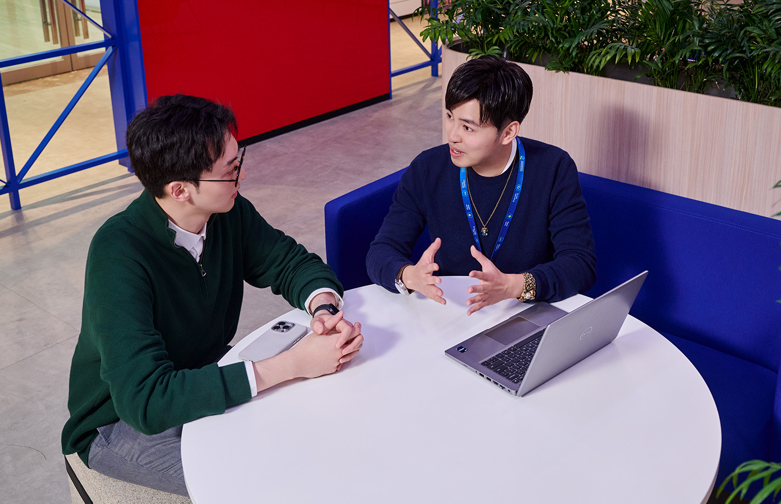 Colleagues discuss skills at a breakout area in a Standard Chartered office.