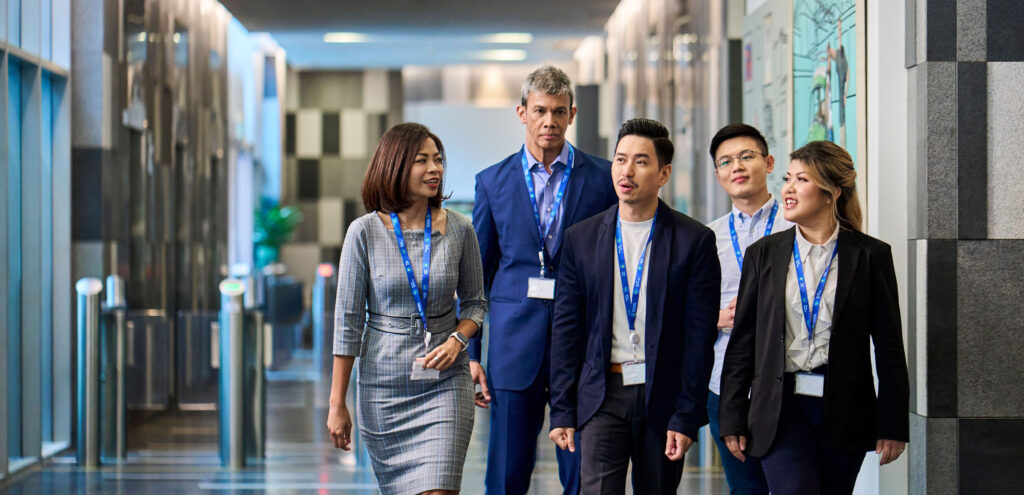 Colleagues walk through a lobby together.