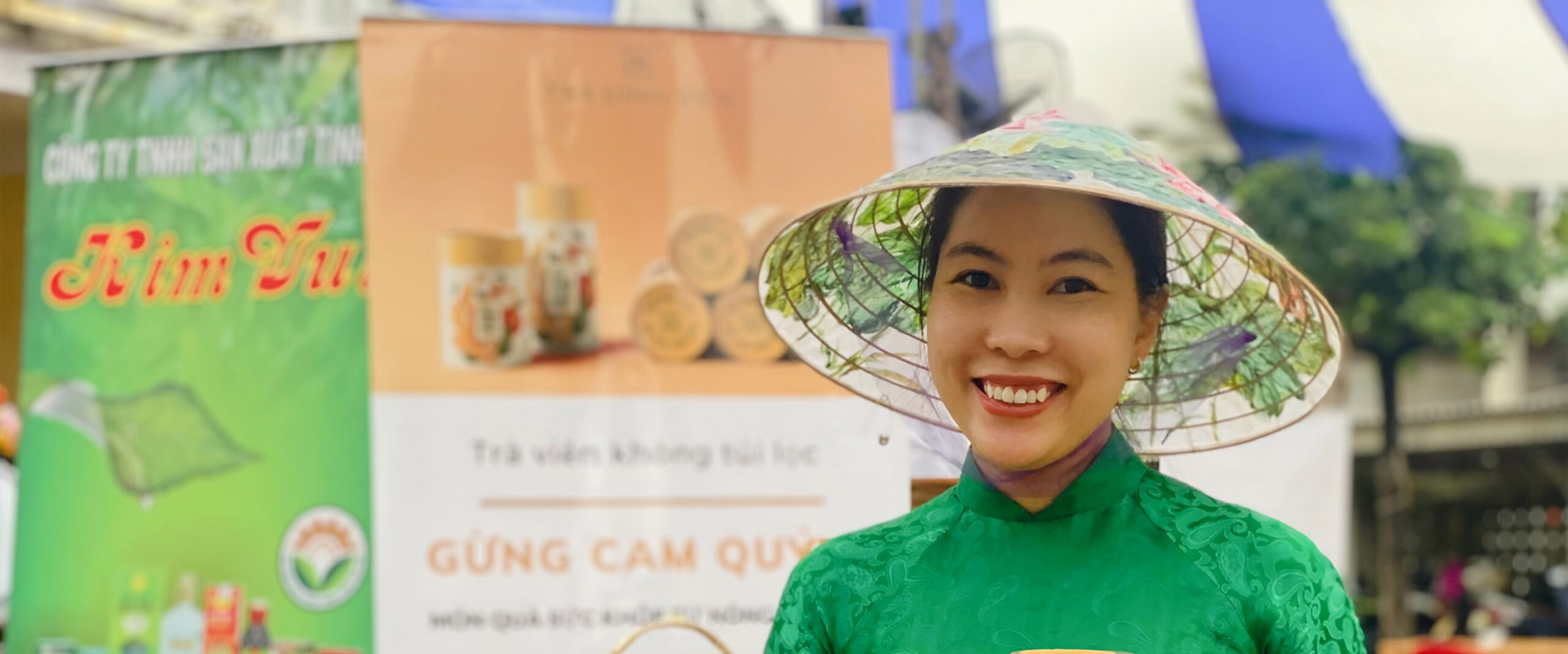 A business woman and Futuremakers participant poses with a product in traditional Vietnamese dress