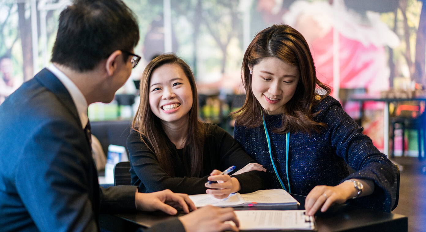 people having conversation looking at paperwork